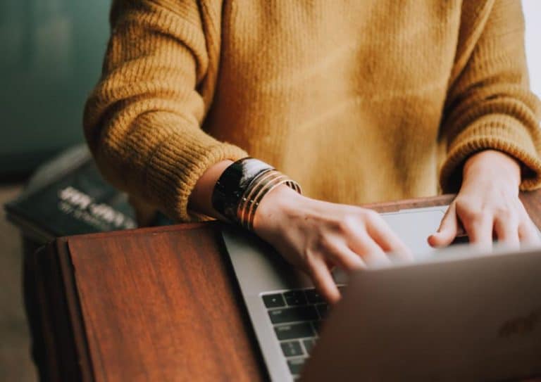 Close up of someone typing on laptop