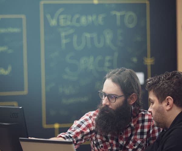 Two people looking at a computer