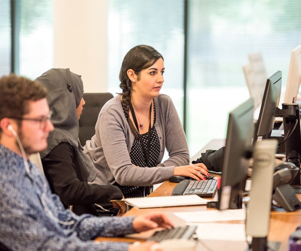 People working on computers in workspace